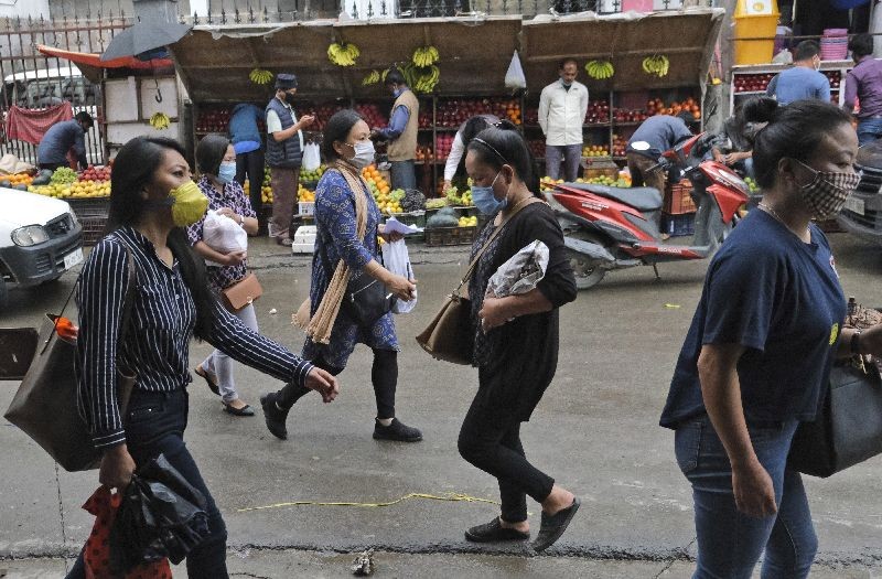 Naga women wearing masks walk in a market area in Kohima, capital of the northeastern Indian state of Nagaland, Wednesday, June 10, 2020. India reported a new rise of nearly 10,000 coronavirus infections Wednesday, with a total caseload of 276,583, the fifth highest in the world. There has also been a surge in infections in rural India following the return of hundreds of thousands of migrant workers who lost their jobs during the lockdown. (Photo by Yirmiyan Arthur/AP Photo)